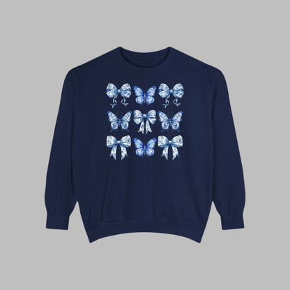 Image: Elegant yet comfortable sweatshirt for women with blue toile butterflies and bows, blending classic charm with modern softness. Sized XS to XL and designed for matching with toddlers and girls, this sweatshirt brings Texas coquette and coastal cowgirl fashion into the family wardrobe. A must-have for casual spring days, by jaecrece.