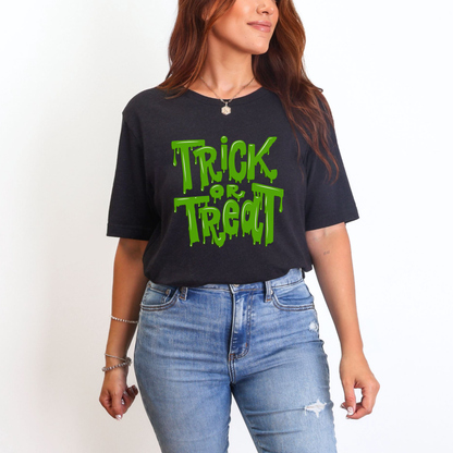 Soft unisex Halloween shirt with Trick or Treat printed in oozing green slime. A perfect mix of humor and horror, this Halloween tee adds bold style to your spooky season. Whether you’re handing out candy or attending a haunted event, this shirt is comfy, festive, and available in inclusive sizes XS through 5XL.
