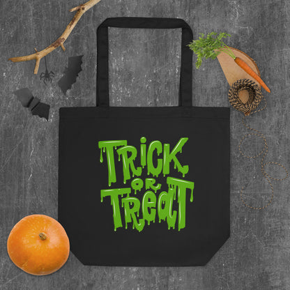 Black Trick or Treat Tote Bag with green slime font, crafted from 100% organic cotton for eco-friendly Halloween fun. Perfect as a trick-or-treat candy bag for kids or adults, this reusable tote holds up to 30 lbs and is built to last beyond Halloween night. Ideal for carrying candy, party favors, or everyday essentials, this sustainable Halloween bag combines spooky style with durability and practical function.