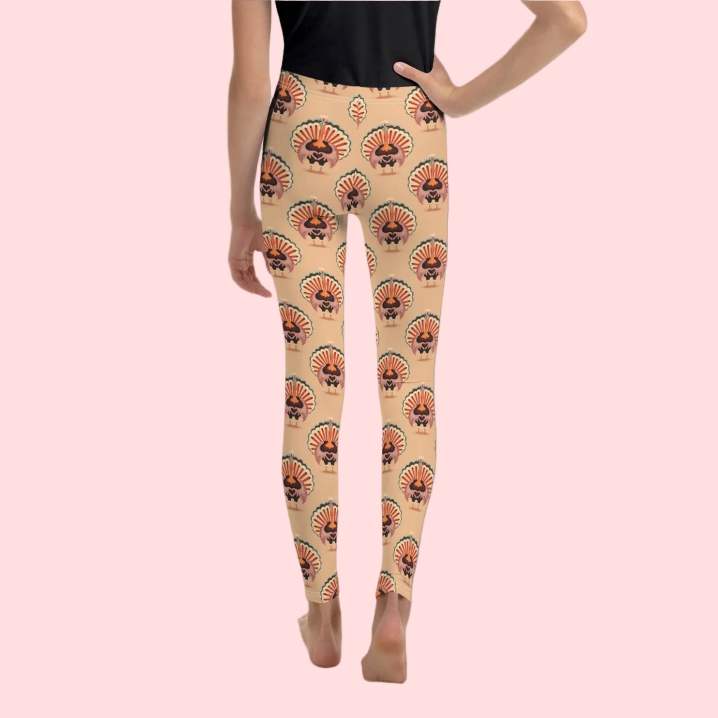 Thanksgiving Turkey Love child leggings. These girls yoga pants are peach, and have a repeating pattern of turkeys showing the love sign with their hands. These girls child tights make a great gift, or a family matching outfit for the Turkey Trot! by jaecrece