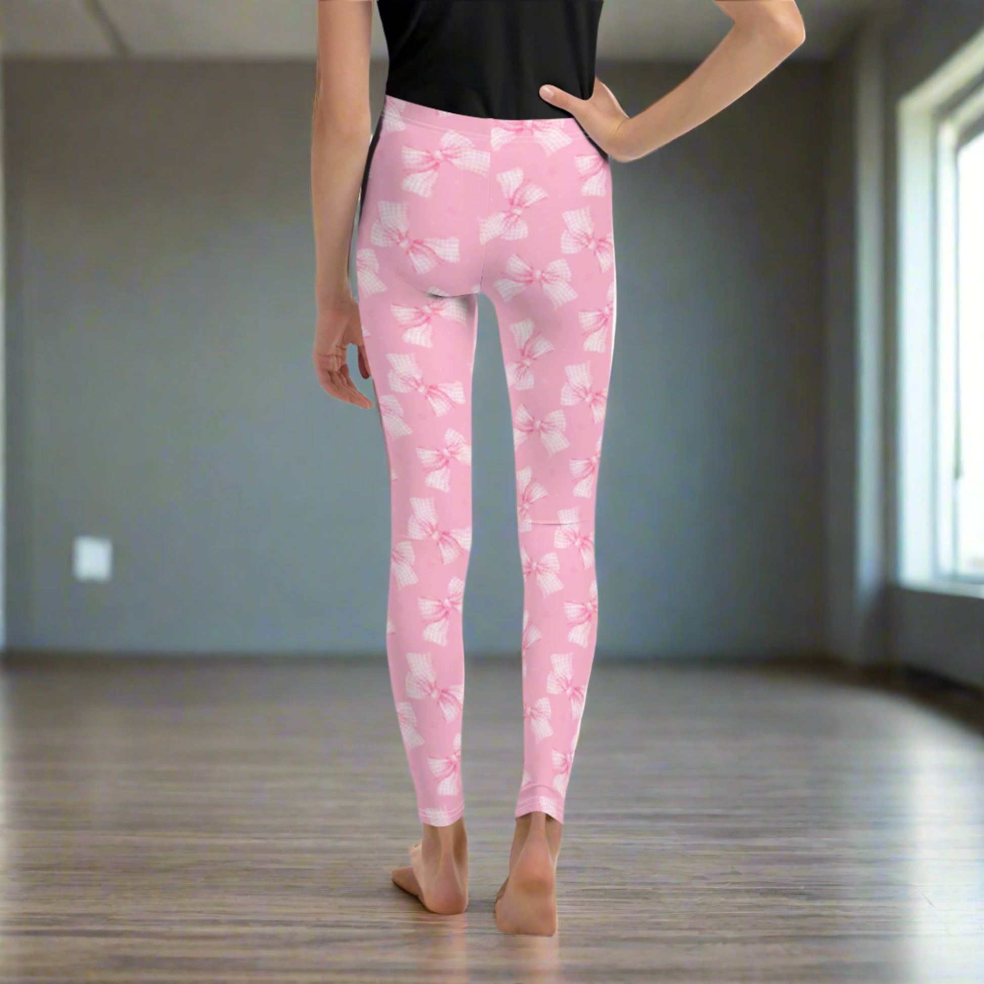 Image: Tween and teen girls will love these youth-sized leggings with pink gingham bows and a soft coquette vibe. Available in sizes 8 through 20, these leggings are great for casual days or dressing up with friends. With cozy fabric and a sweet aesthetic, they are an excellent birthday gift or addition to a stylish school wardrobe, by jaecrece.
