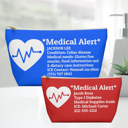 Two custom medical alert pouches, one blue and one red, displayed on a white surface with a blurred bathroom background. Each pouch features a white heart with a heartbeat line, the text '*Medical Alert*', and customizable personal information.