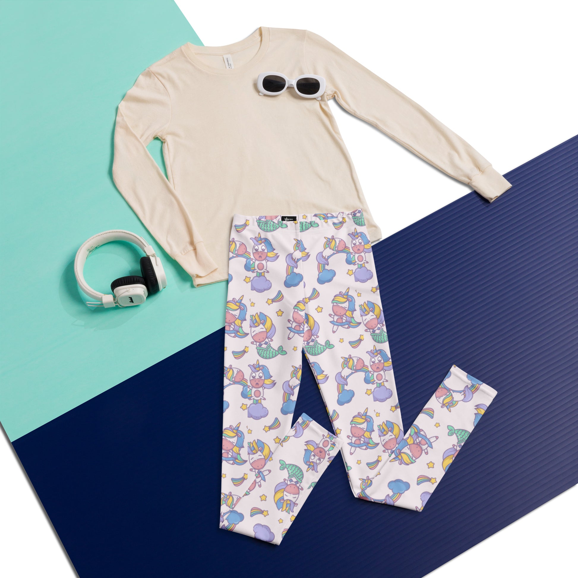 Girls mermaid unicorn kawaii youth leggings featuring a pale pink background with pastel unicorn characters, rainbows, clouds, stars, and moons. These high waist girls leggings are made from soft microfiber fabric with four way stretch, offering comfort for school, yoga, lounging, and everyday play. Whimsical unicorn leggings for kids who love fantasy fashion, pastel aesthetic outfits, unicorncore style, and playful activewear for tweens.