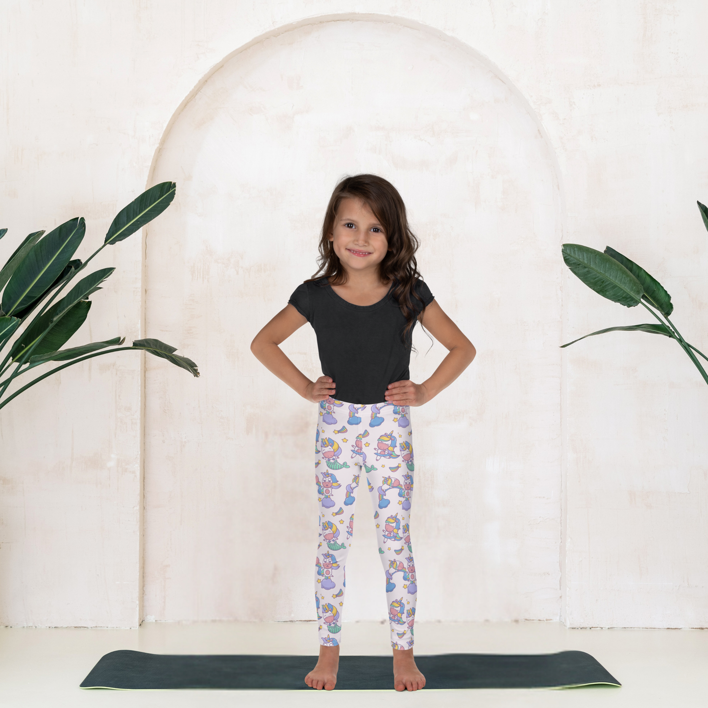Kawaii girls leggings with mermaid and unicorn print in pastel colors on a pink base, designed for toddlers and young girls who love fun and magical clothing. High rise waistband and ankle length fit provide comfort for all day wear. Soft stretchy fabric moves easily with active kids during school, playdates, or lounging at home. A cute everyday outfit option inspired by fantasy themes, perfect for playful and imaginative kids fashion.