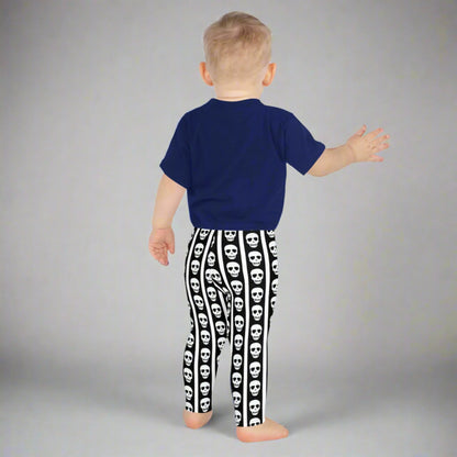 Image: For spooky season or year-round fun, these kids leggings feature vertical stripes in black and white with skulls lined up on each leg. Designed with comfort and play in mind, these soft leggings are ideal for imaginative dress-up or casual outings. Offered in toddler and youth sizes, they bring playful edge to every outfit for your tiny trendsetter, by jaecrece.