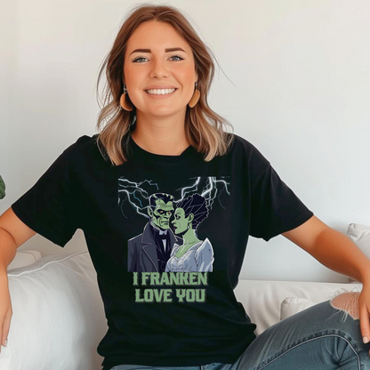 Unisex black Halloween graphic shirt featuring romantic Frankenstein and his bride, lightning in background, “I Franken Love You.” Soft Gildan 64000 tee, S-5XL, perfect for couples, spooky parties, Halloween gifts, or playful monster-themed casual wear.