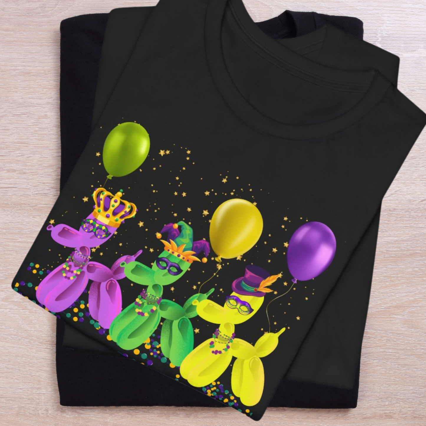 Image: Mardi Gras Balloon Dog Adult Shirt. This New Orleans Carnival tee features three balloons dogs, wearing Mardi Gras masks and hats. They have beads and balloons with confetti, by jaecrece