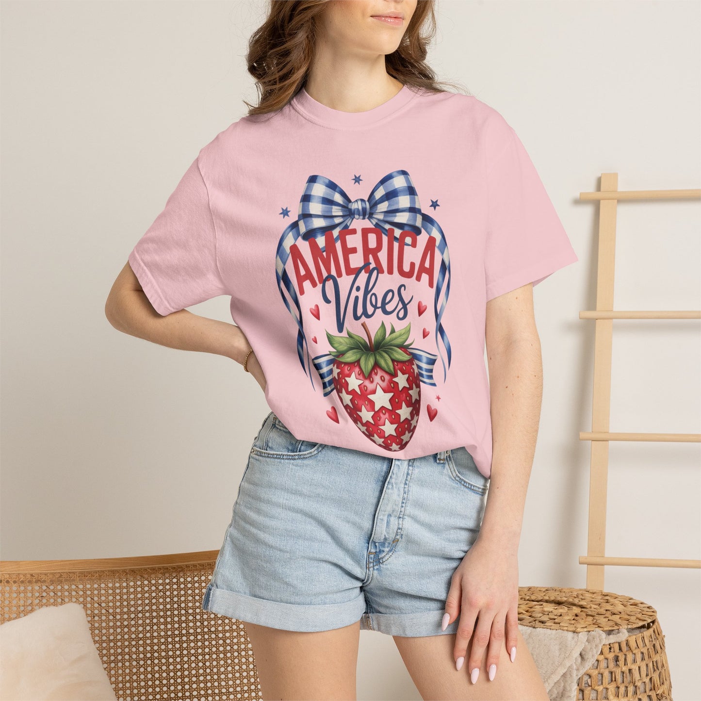 Vintage Americana strawberry graphic t shirt printed on Comfort Colors 1717 garment dyed cotton featuring patriotic stars gingham bow artwork and sweet summer inspired details. Relaxed unisex fit tee perfect for America 250 celebrations 4th of July outfits patriotic family photos mommy and me matching outfits Memorial Day vacations and casual red white and blue holiday style