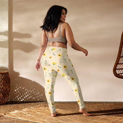 Sunflower leggings featuring a vintage botanical inspired print with yellow flowers and delicate green foliage scattered across a soft cream background. The illustrated style gives the design a nostalgic garden feel without being overly bold. These women's full length leggings are easy to dress up or down and can be worn for casual days, outdoor activities, yoga, walking, travel, or relaxed cottagecore inspired outfits.