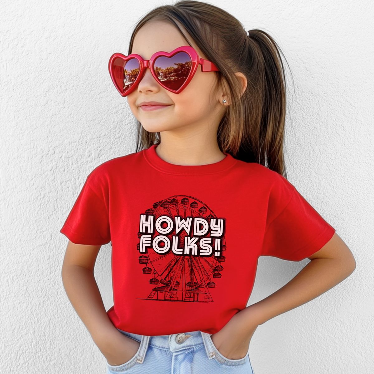 Vintage Ferris wheel kids shirt featuring bold HOWDY FOLKS lettering in a colorful retro fairground design. This State Fair of Texas youth tee is perfect for children who love carnival rides, county fairs, festivals, and family fair days. The nostalgic graphic makes a fun fair outfit for photos, outings, and annual State Fair traditions, with a matching adult shirt available for family looks.