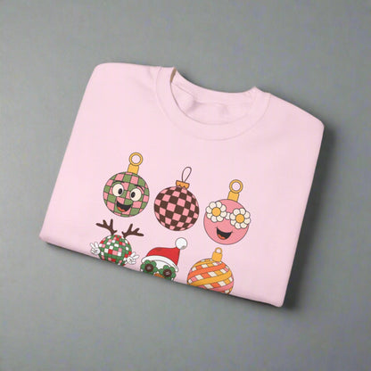 Retro holiday sweatshirt with nine colorful ornament designs, including flowers, checkered patterns, and a retro Santa with sunglasses. This fun Christmas crewneck is printed on Gildan 18000 and comes in light pink, black, or sand. Available in sizes S–5XL, it makes a playful Christmas party outfit, vintage holiday wardrobe staple, or retro Christmas gift. Cozy and unisex, this festive pullover is perfect for spreading cheerful and groovy holiday vibes.
