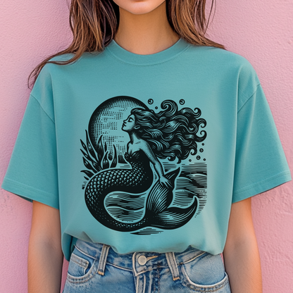 Image: Comfort Colors Vintage Mermaid T-shirt with antique-style nautical artwork featuring a siren of the sea. Perfect for lovers of coastal cowgirl, mermaidcore, and fisherman aesthetic, this relaxed-fit tee is ideal for beach strolls, boating days, or vintage-inspired summer fashion. Soft-washed cotton makes it comfy for everyday wear, blending soft girl vibes with maritime charm, by jaecrece.

