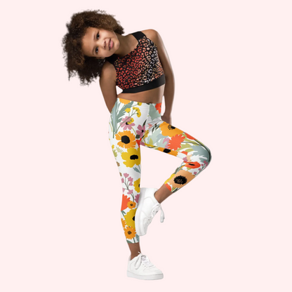 Image: Watercolor wildflower toddler leggings in sizes 2T–7 with bright floral print on a white background, perfect for spring outfits, Easter egg hunts, garden parties, and family photos. These comfy pants offer stretch and softness for active little girls. Match them with coordinating leggings for older kids and moms for a charming family look ideal for casual events and holidays, by jaecrece.

