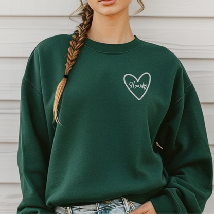 Western style Howdy embroidered sweatshirt on Gildan 18000 unisex crewneck with soft cotton blend fabric and relaxed fit. Designed for college game day outfits, football tailgates, and stadium cheering in Texas. Cozy fall sweatshirt perfect for layering with jeans or boots. Available in maroon, black, green, pink, and dark gray tones. Ideal sporty western aesthetic for women, students, and football fans.