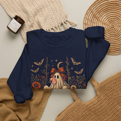 Whimsigoth inspired women's Halloween sweatshirt featuring a vintage ghost seated on a swing and blowing bubble gum. Floral details, botanical foliage, bats, lace, stars and a crescent moon create a romantic spooky season look with vintage gothic character.