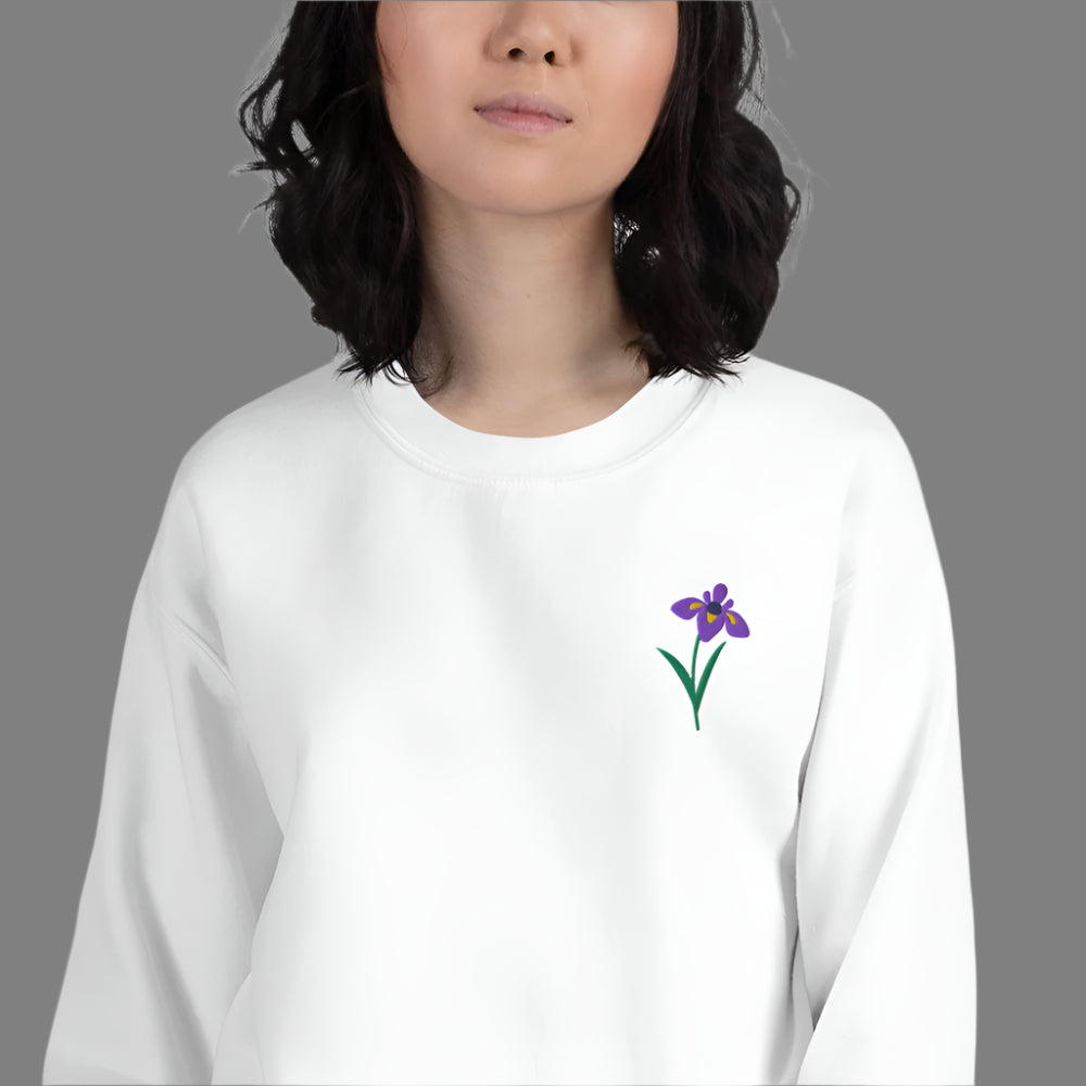 Image: A beautifully embroidered iris flower crewneck sweatshirt in a soft, relaxed fit. This custom floral design adds an elegant touch to any wardrobe, making it a meaningful Mother's Day gift or a thoughtful present for nature lovers. The intricate embroidery captures the essence of the bearded iris, creating a timeless piece that celebrates botanical beauty and personal style, by jaecrece.