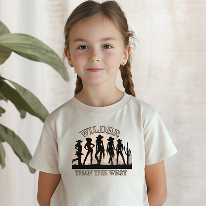 Toddler western tee in soft natural features five bold cowgirl silhouettes, desert cactus, and sunset with the slogan “Wilder than the West.” Designed for southern mini cowgirls, this toddler graphic shirt pairs with women’s and girls’ tees for a fun mama and mini matching outfit. Ideal for rodeos, bachelorette trips, country music festivals, or casual Texas state fairwear. Adds a playful vibe to toddler desert-themed wardrobes.