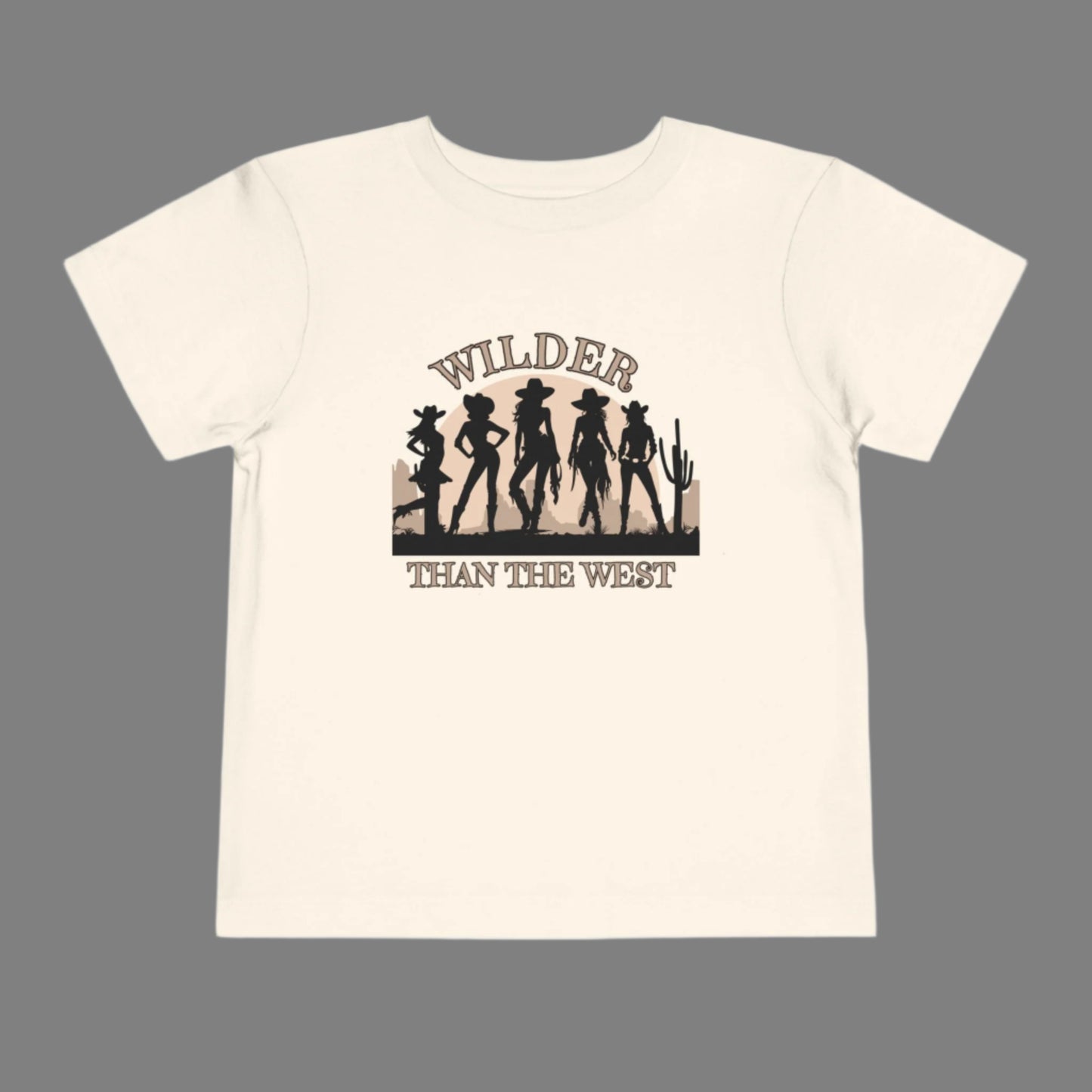 Wilder than the West toddler tee with a bold cowgirl graphic is perfect for girls who love rodeo rides and dusty trails. Designed in soft natural, this western silhouette shirt for toddlers pairs effortlessly in mama mini sets for festivals, birthdays, or Texas fair events. A comfy toddler country girl shirt with vintage vibes and a strong western quote—great for southern babes and little cowgirls in training.