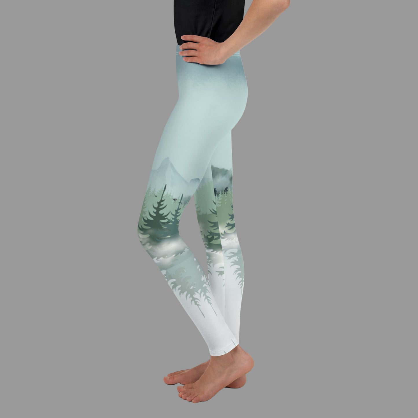Snowy Mountain Winter Forest Youth Leggings, part of a family matching activewear collection for kids 8–20. Perfect for ski lodge vacations, winter holiday trips, outdoor adventures, cozy après-ski lounging, and family photo outfits. Smooth microfiber yarn with four-way stretch allows comfort and movement while durable overlock stitching ensures longevity. Eco-conscious, made-to-order design keeps your family stylish and coordinated.