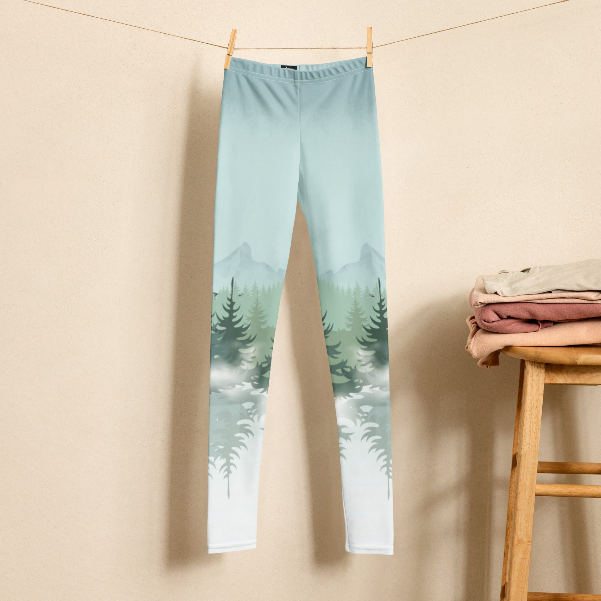 Winter Forest Youth Leggings in sizes 8–20 featuring pine tree and snowy mountain graphics. Family matching activewear designed for mountain vacations, ski lodge trips, cozy winter play, outdoor adventures, and memorable holiday photos. Comfortable microfiber yarn with four-way stretch, overlock stitching, and durable construction. Made-to-order eco-friendly leggings perfect for stylish, coordinated family outfits during winter.