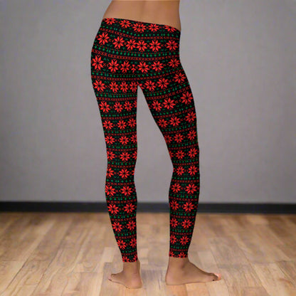 Christmas poinsettia leggings with a black base and red and green geometric fair isle design, made for women who love cozy and stylish holiday outfits. These mid rise full length leggings offer a soft stretchy feel, perfect for lounging, festive events, and winter fashion looks. Great for mommy and me matching outfits, boutique style wardrobes, and seasonal gift ideas.