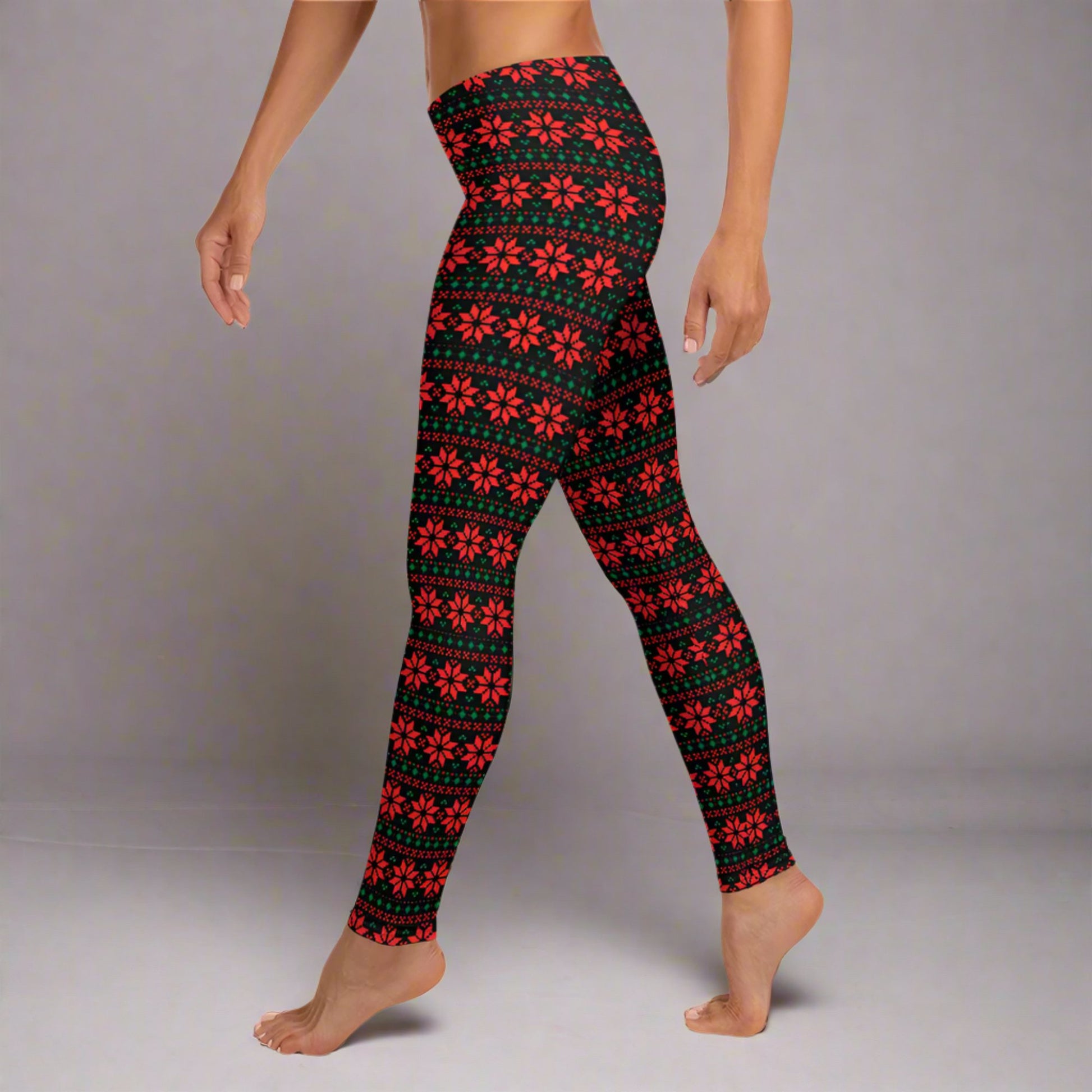 Black holiday leggings with red and green poinsettia design in a geometric fair isle style, perfect for creating a cozy and festive winter outfit. Mid rise waist and full length fit provide comfort and a flattering look for Christmas parties, lounging, and everyday wear. Great for mommy and me outfits, matching family looks, and shoppers searching for cute Christmas leggings.