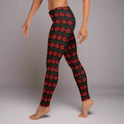 Black holiday leggings with red and green poinsettia design in a geometric fair isle style, perfect for creating a cozy and festive winter outfit. Mid rise waist and full length fit provide comfort and a flattering look for Christmas parties, lounging, and everyday wear. Great for mommy and me outfits, matching family looks, and shoppers searching for cute Christmas leggings.