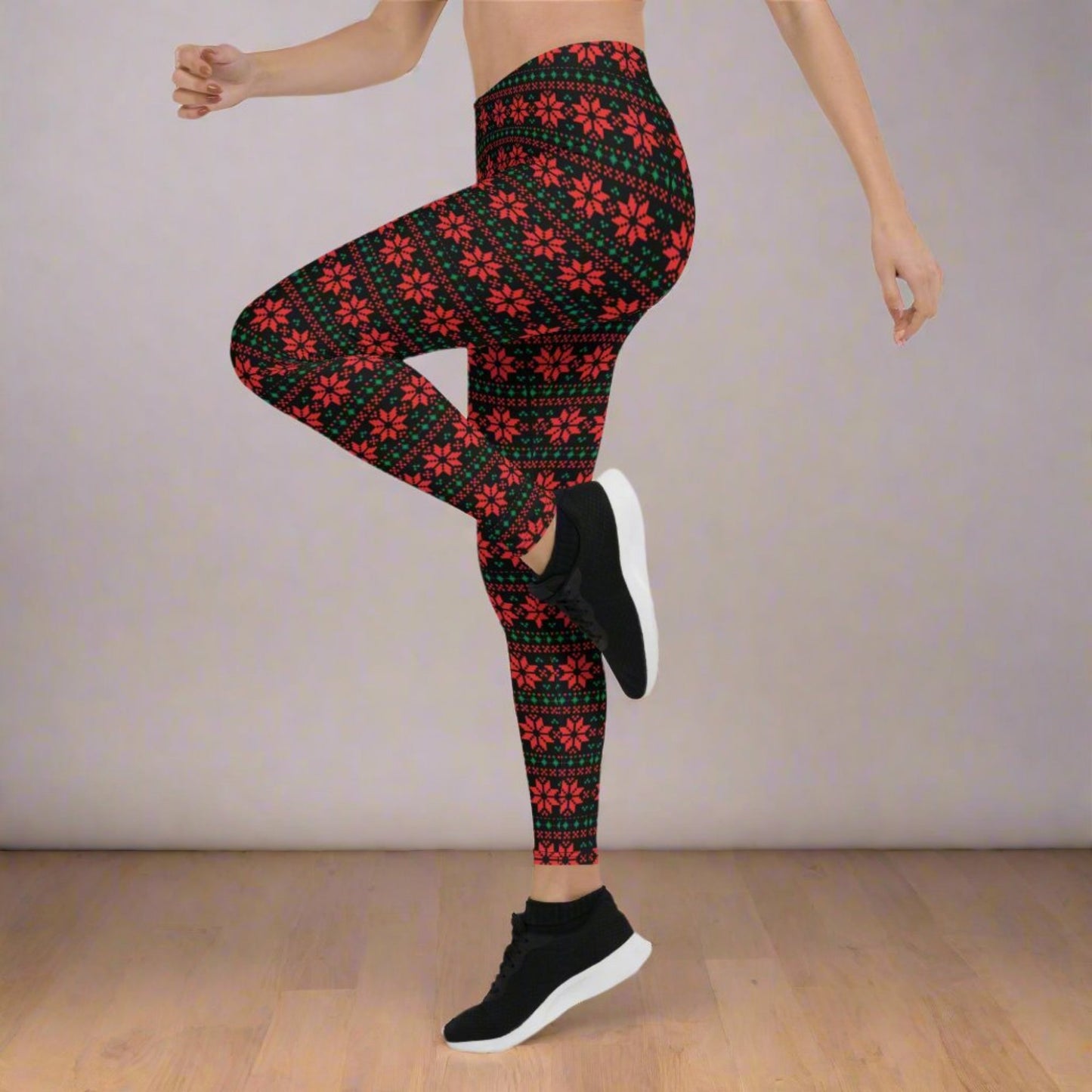 Festive black leggings with red and green poinsettia design in a fair isle inspired geometric pattern, perfect for holiday outfits and winter style. These mid rise full length leggings offer a soft stretchy fit for comfort during Christmas celebrations, lounging, and family photos. Great for mommy and me matching outfits, boutique clothing shoppers, and anyone looking for unique Christmas leggings with bold seasonal flair.