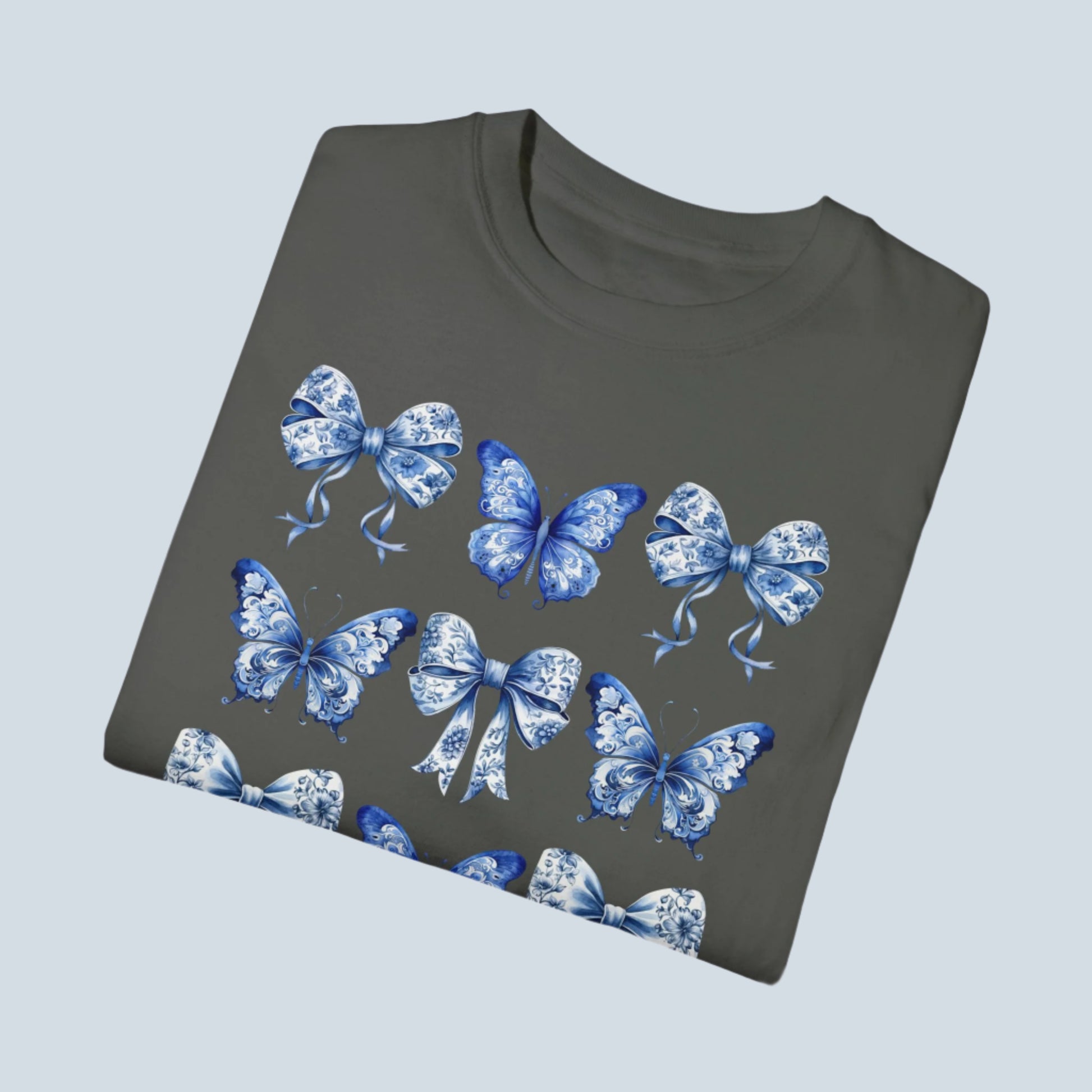 Image: Women’s shirt with blue toile bow and butterfly design, perfect for soft girl outfits and chic French-inspired wardrobes. This classic yet trendy top complements the coastal cowgirl aesthetic, making it ideal for stylish moms who love feminine flair. Part of a family matching set that includes toddler and youth sizes—great for events, holidays, or everyday family moments in coordinated style, by jaecrece.