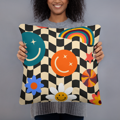 A smiling woman holding a square Y2K smiley face checkerboard throw pillow, showing scale and how cute and comfortable it looks when styled as a fun accent for teen bedrooms, dorm rooms and cozy apartments. Retro black and tan check pattern with cheerful smiley icons adds playful soft girl aesthetic décor to any space. Double sided printed pillow ideal for gifting to décor loving friends who want trendy stylish and happy room décor accessories.