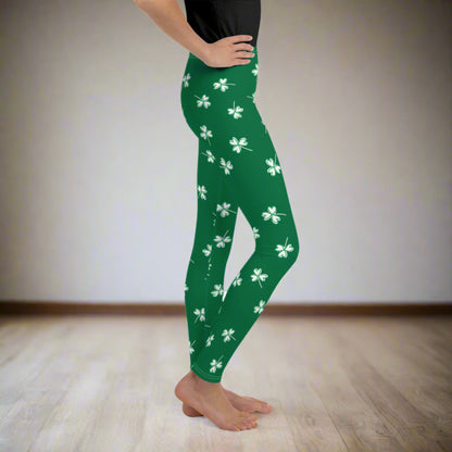 Image: Family Matching St Patricks Day Shamrock Leggings. Festive yoga pants with green background and white four leaf clovers. Available in sizes for toddler girls, teens, tweens, and women. Perfect for a St Pattys Day parade or fun run, by jaecrece