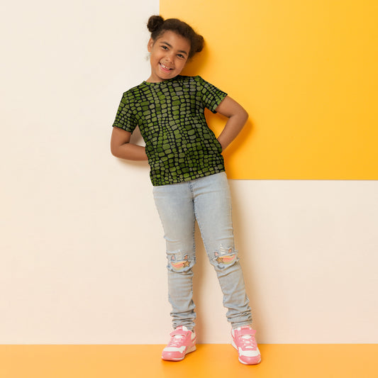 Green scale reptile print kids t-shirt in sizes 2T–7, designed for imaginative play and costume fun. Perfect for dinosaur, lizard, snake, or serpent-themed outfits, this all-over print tee features vivid green scales and a soft, comfy fit. Ideal for Halloween, dress-up days, or jungle animal birthday parties. A must-have for kids who love reptiles and creative play, this shirt brings wild adventures to life.