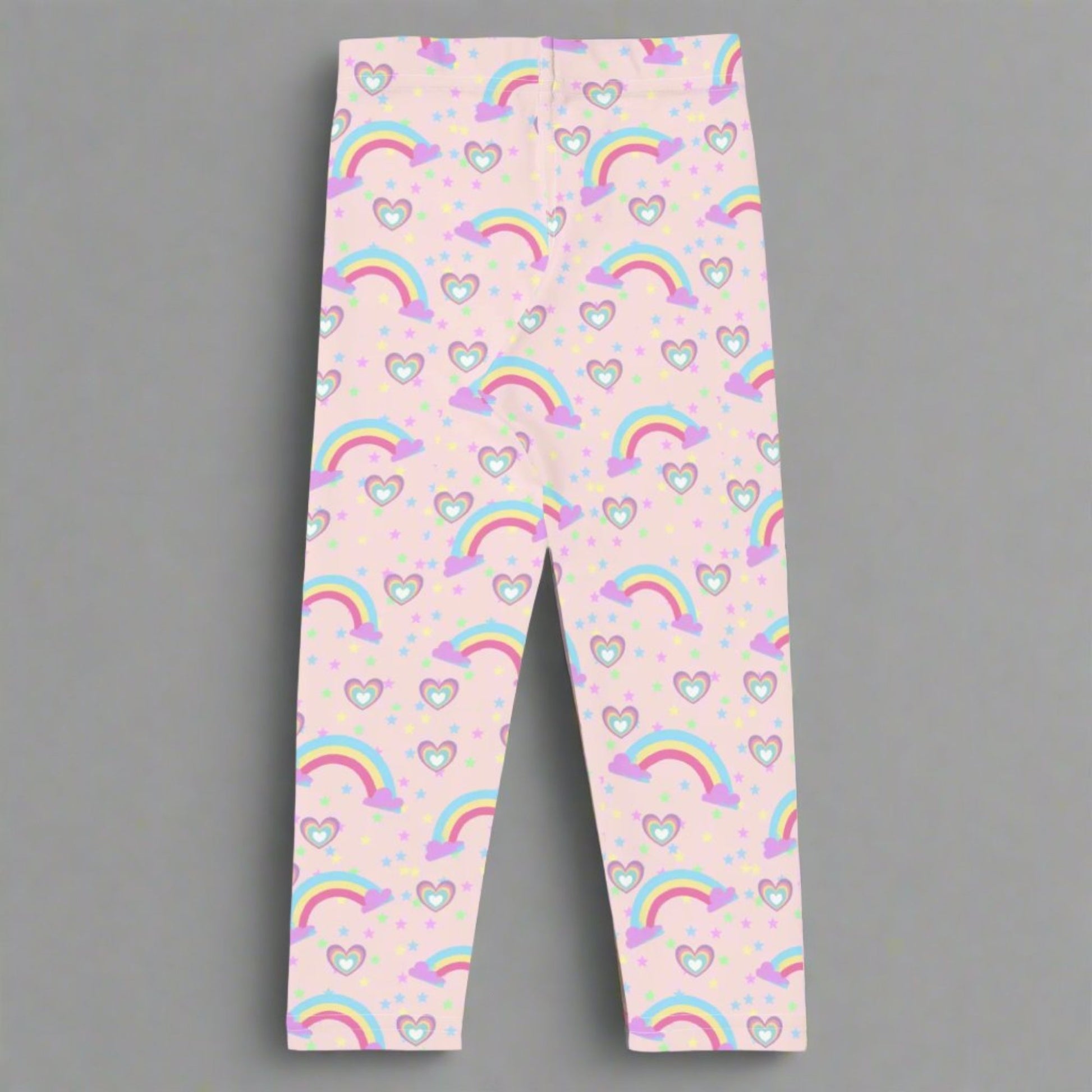 Pink Fairy Tale Todder Girl Leggings. These pants feature a light pink background with a pattern of stars, hearts and rainbows, by jaecrece