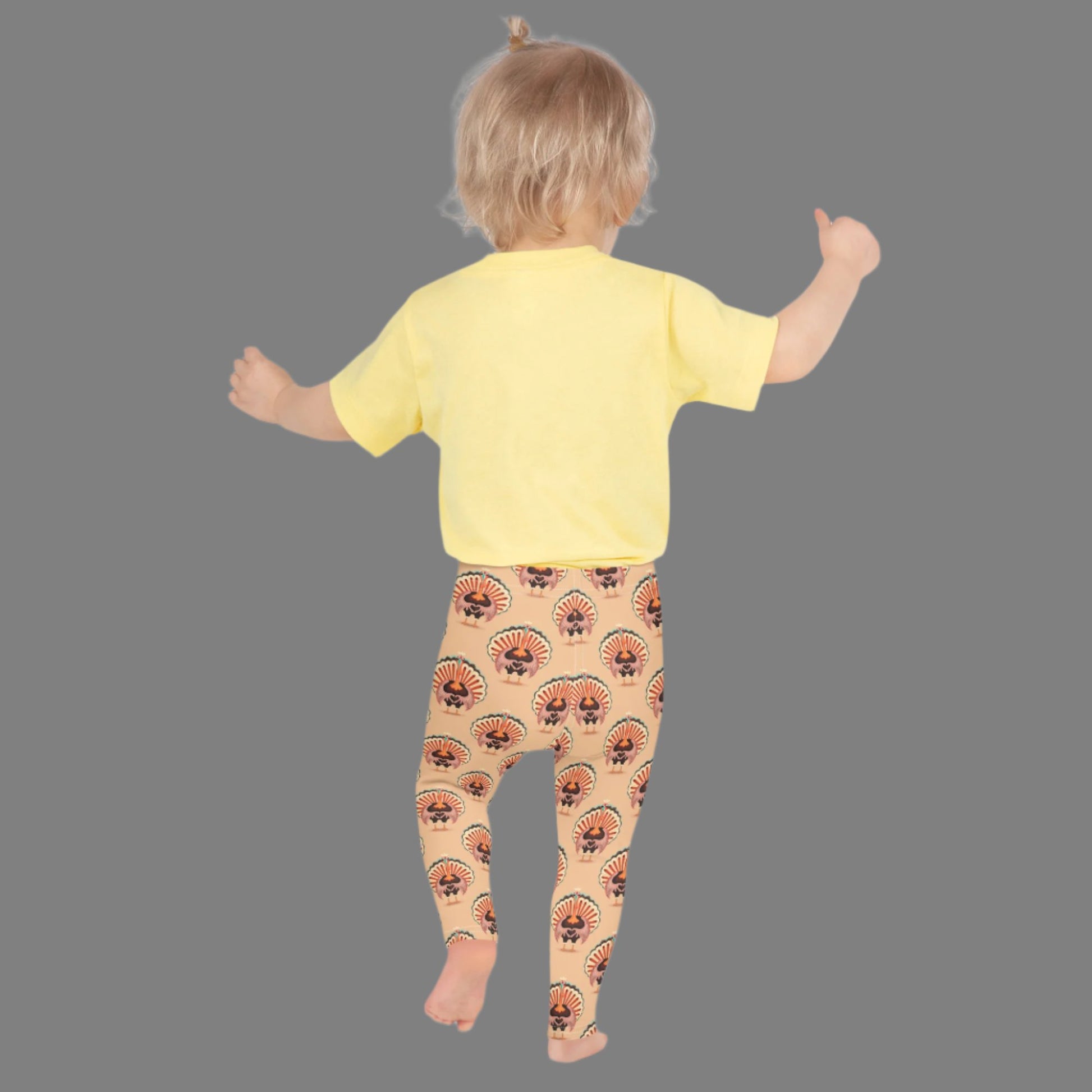 Thanksgiving Turkey Love Toddler leggings. These yoga pants are peach, and have a repeating pattern of turkeys showing the love sign with their hands. These girls child tights make a great gift, or a family matching outfit for the Turkey Trot! by jaecrece