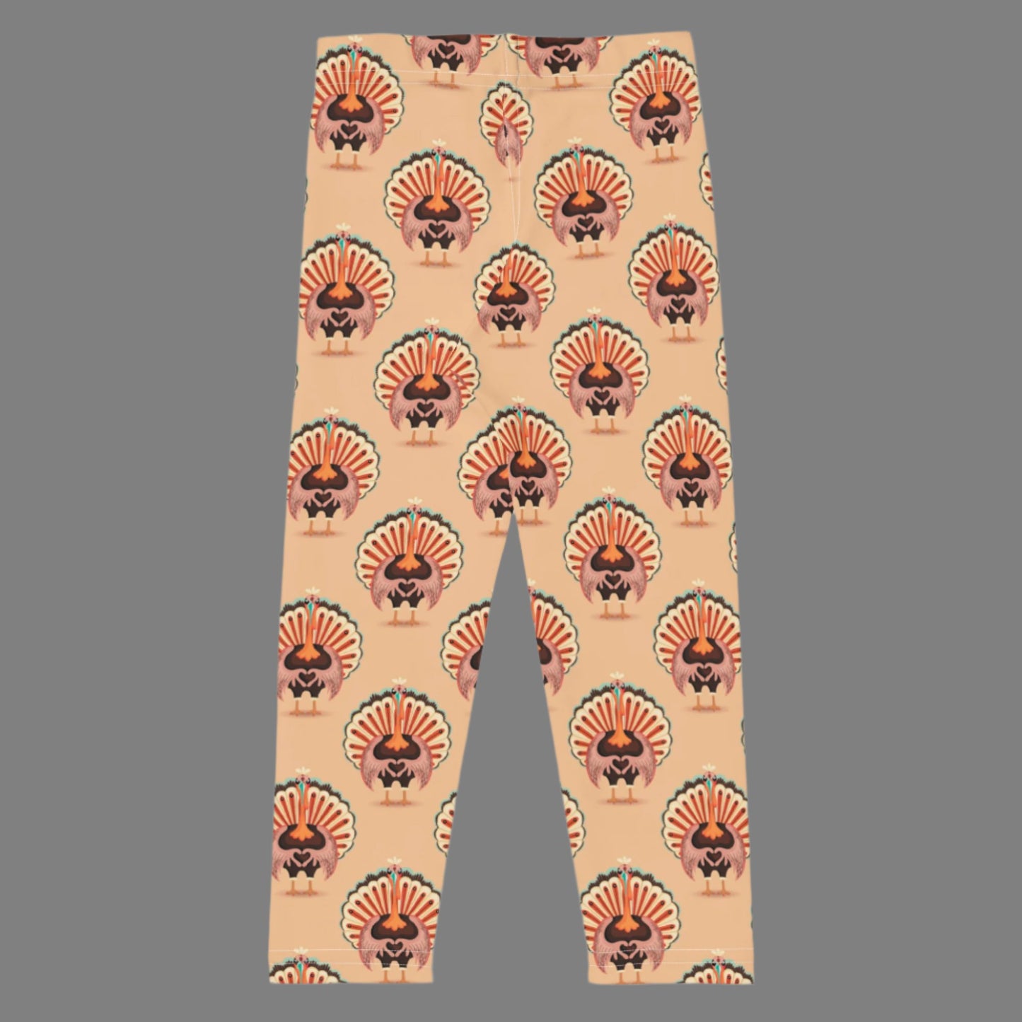 Thanksgiving Turkey Love Toddler leggings. These yoga pants are peach, and have a repeating pattern of turkeys showing the love sign with their hands. These girls child tights make a great gift, or a family matching outfit for the Turkey Trot! by jaecrece