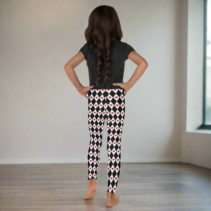 Image: Harlequin Love Girls Leggings in sizes 2T-7. These yoga tights have a black and white checker/ diamond pattern with a red heart accent, the perfect leggings for valentines day or a Queen of Hearts costume, by jaecrece