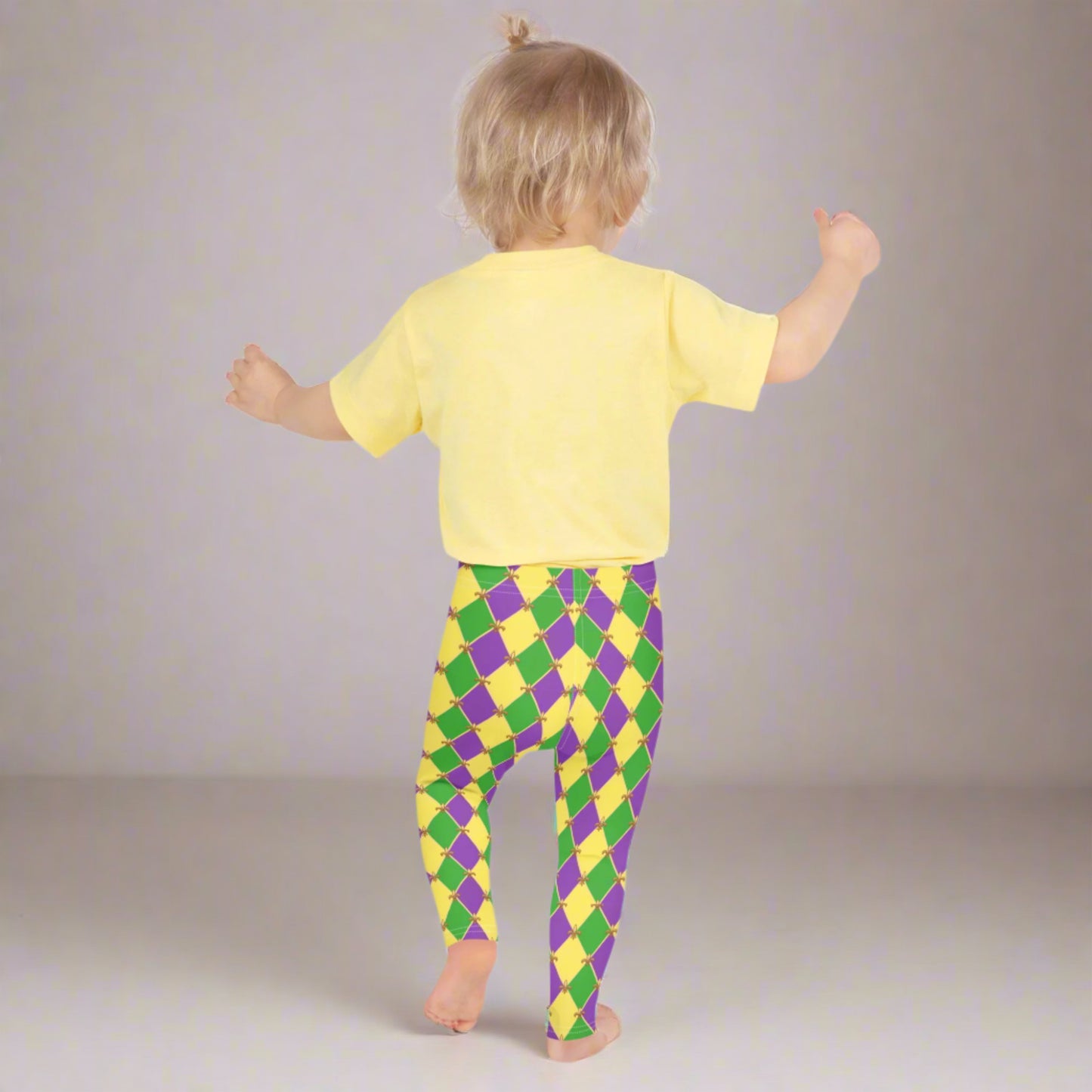 Image: Mardi Gras Kids Leggings, in sizes 2T-7. These Canival themed yoga pants feature a gold, green and purple diamond pattern with a fleur de lis accent. Perfect attire for any New Orleans French Quarter parade, by jaecrece