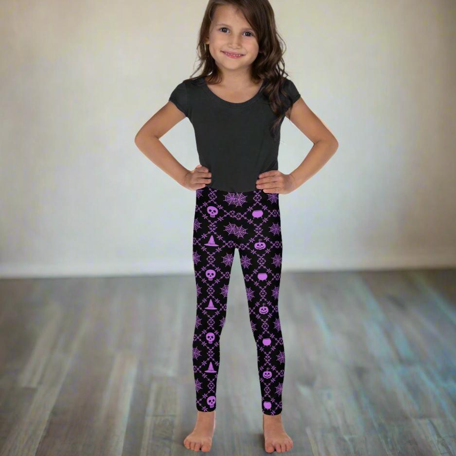 Wickedly Cute Toddler & Kids Halloween Leggings, featuring a black material with a purple geometric pattern that consists of spiders webs, pumpkins, witches hats and skulls, by jaecrece.com