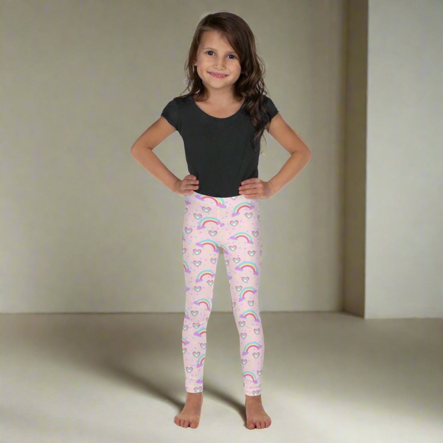 Pink Fairy Tale Todder Girl Leggings. These pants feature a light pink background with a pattern of stars, hearts and rainbows, by jaecrece