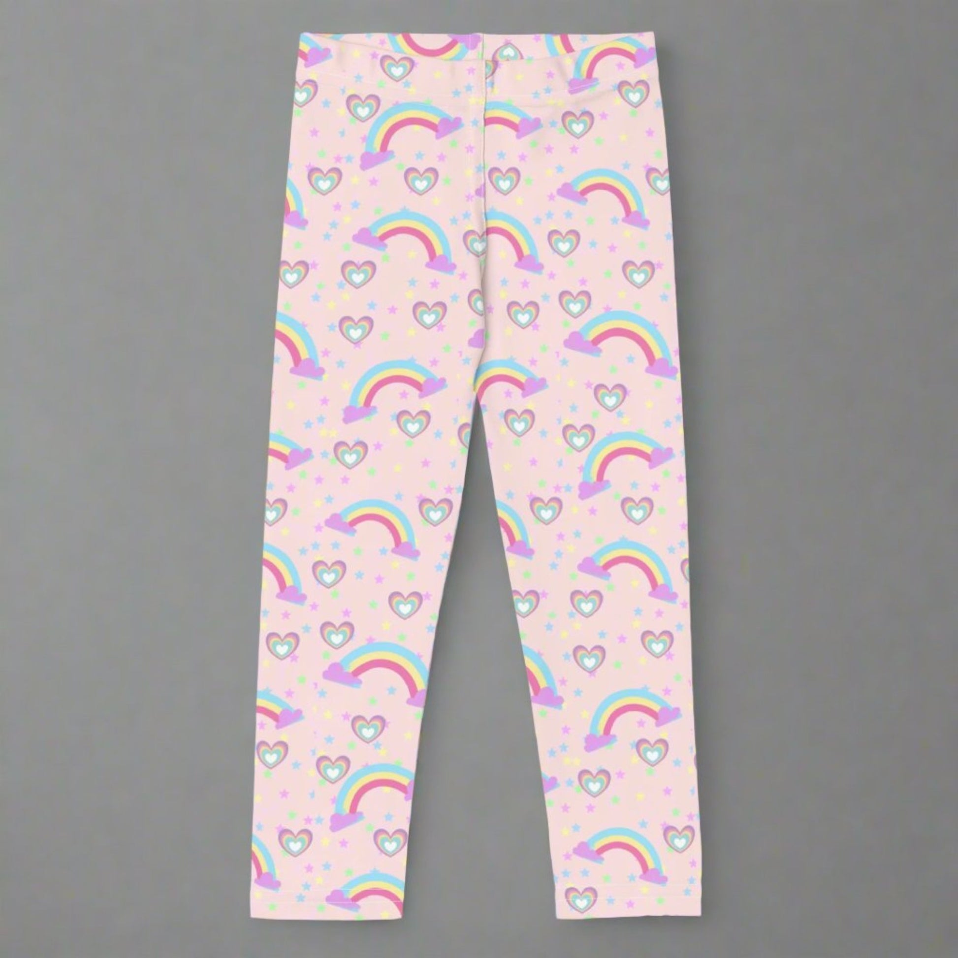 Pink Fairy Tale Todder Girl Leggings. These pants feature a light pink background with a pattern of stars, hearts and rainbows, by jaecrece