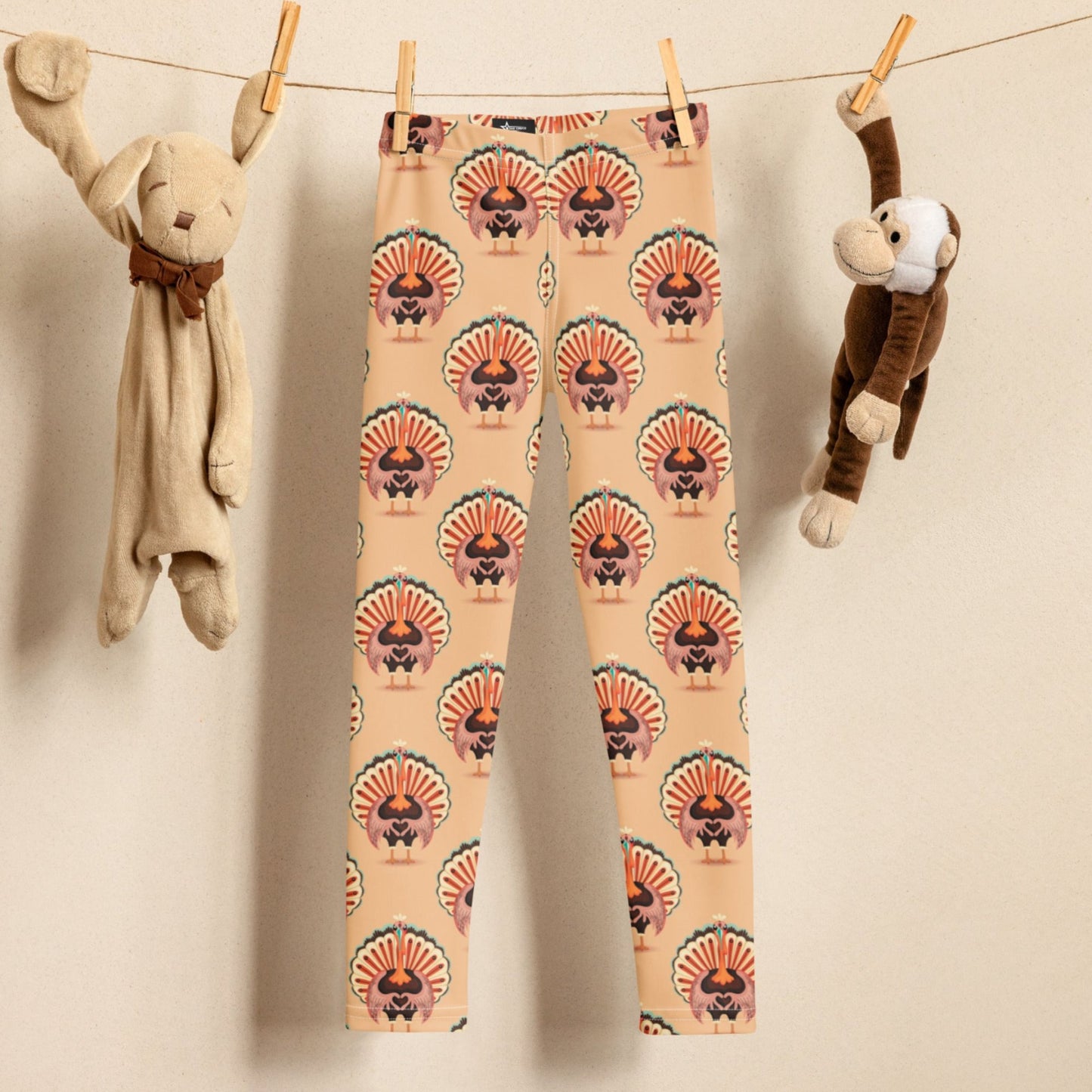 Thanksgiving Turkey Love Toddler leggings. These yoga pants are peach, and have a repeating pattern of turkeys showing the love sign with their hands. These girls child tights make a great gift, or a family matching outfit for the Turkey Trot! by jaecrece