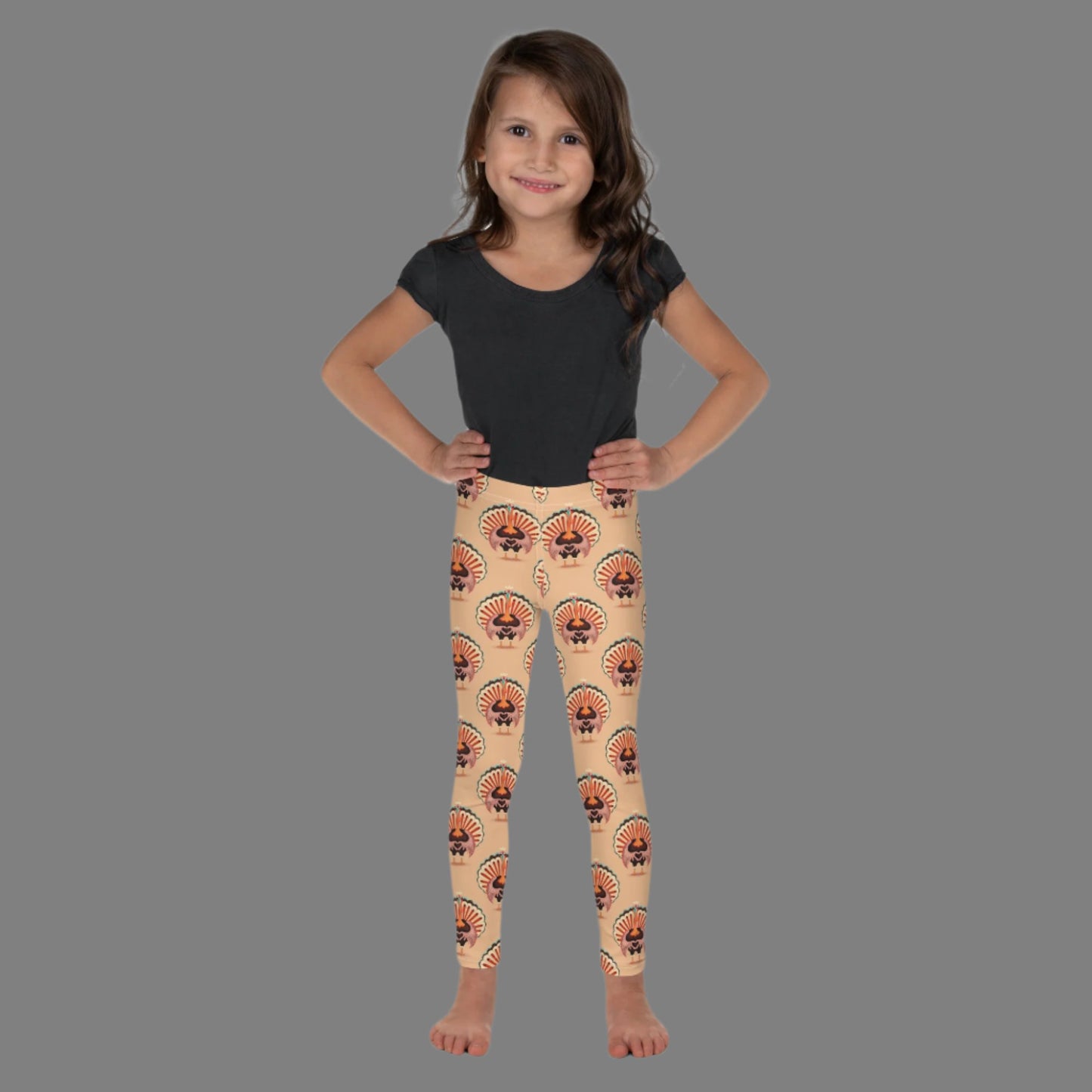 Thanksgiving Turkey Love Toddler leggings. These yoga pants are peach, and have a repeating pattern of turkeys showing the love sign with their hands. These girls child tights make a great gift, or a family matching outfit for the Turkey Trot! by jaecrece