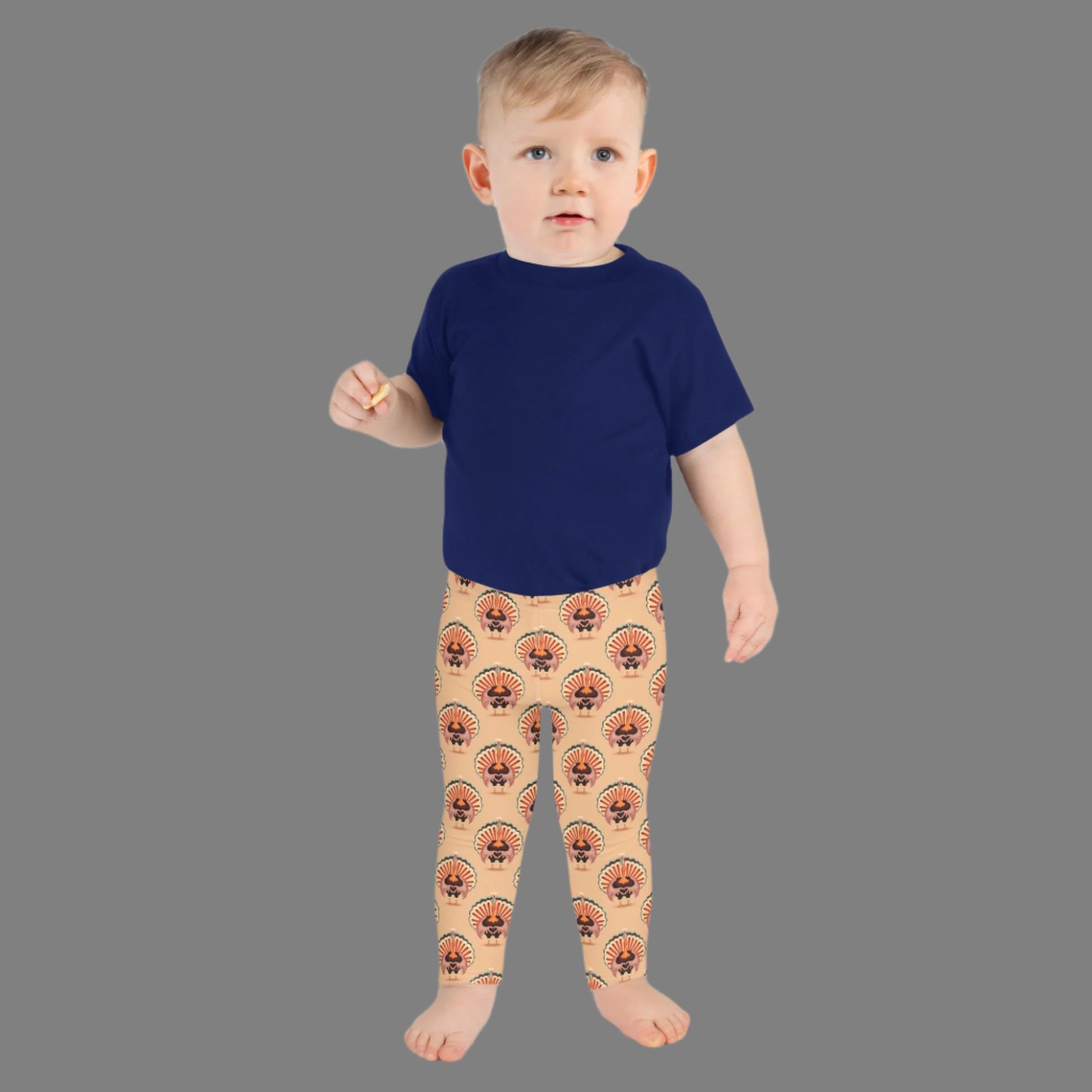 Thanksgiving Turkey Love Toddler leggings. These yoga pants are peach, and have a repeating pattern of turkeys showing the love sign with their hands. These girls child tights make a great gift, or a family matching outfit for the Turkey Trot! by jaecrece