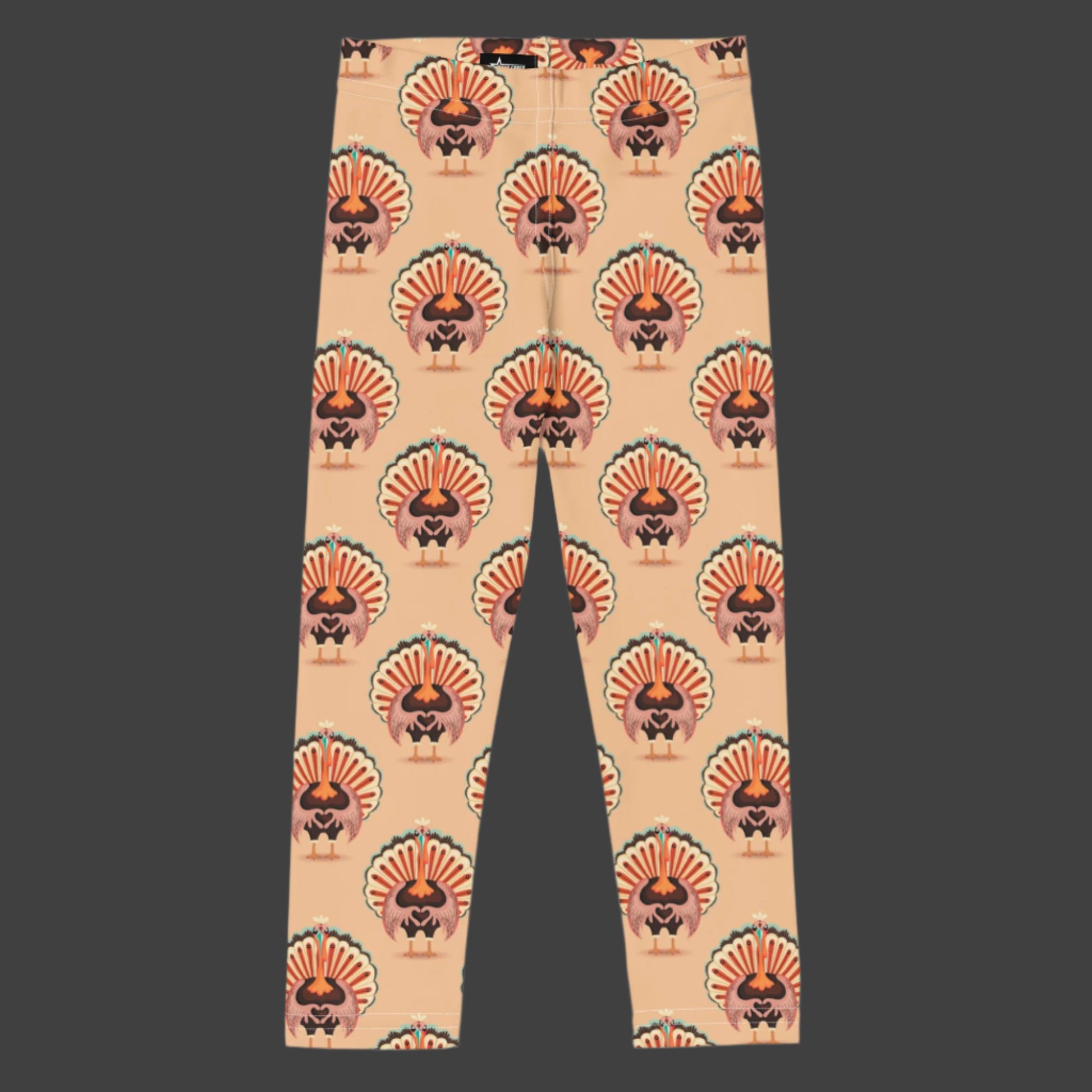 Thanksgiving Turkey Love Toddler leggings. These yoga pants are peach, and have a repeating pattern of turkeys showing the love sign with their hands. These girls child tights make a great gift, or a family matching outfit for the Turkey Trot! by jaecrece