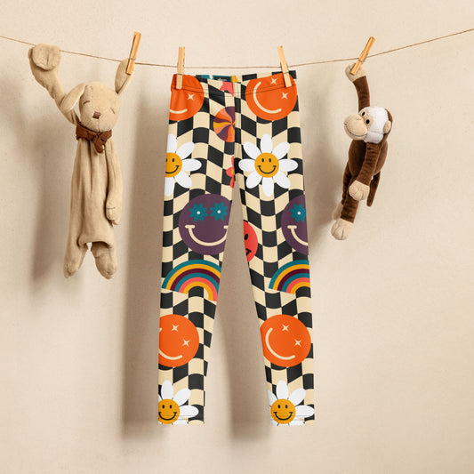 Image: Retro Checkerboard Girls Leggings, in size 2T-7. These toddler and kids yoga pants feature a black and khaki vintage check pattern with smiley faces, daisies, rainbows and suns. These vintage tights make a great birthday present, birthday gift, and are great for back to school, by jaecrece