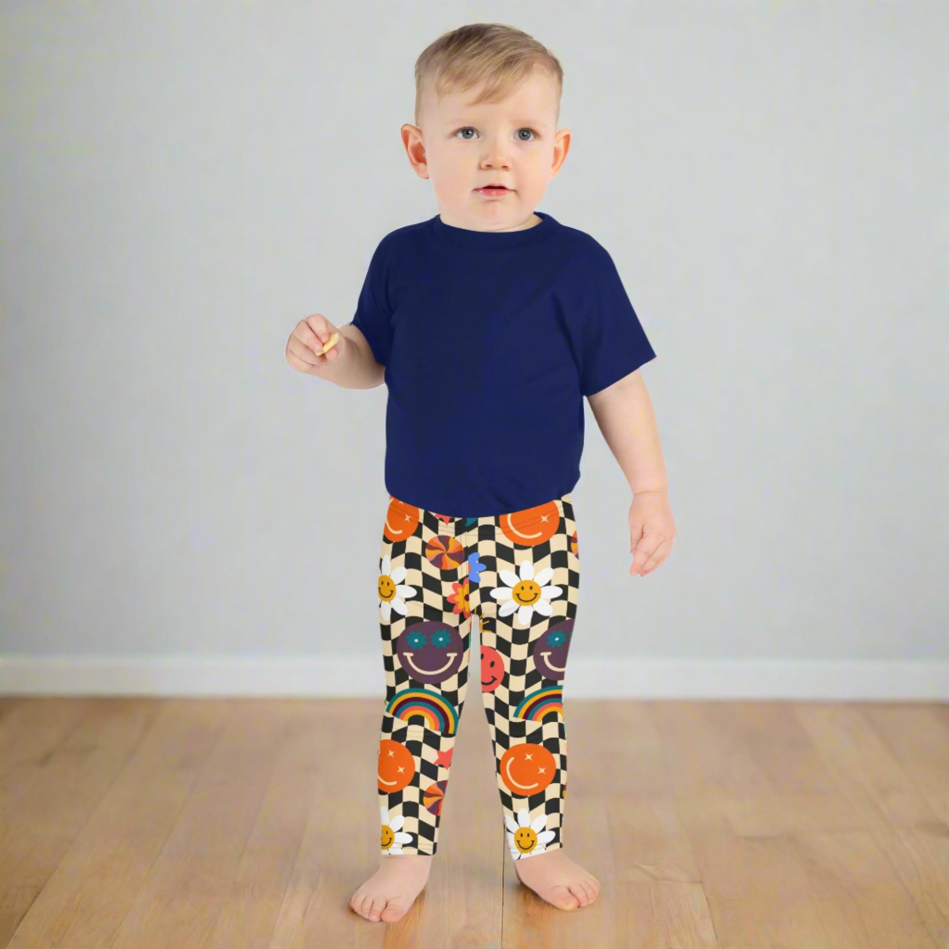 Image: Retro Checkerboard Girls Leggings, in size 2T-7. These toddler and kids yoga pants feature a black and khaki vintage check pattern with smiley faces, daisies, rainbows and suns. These vintage tights make a great birthday present, birthday gift, and are great for back to school, by jaecrece