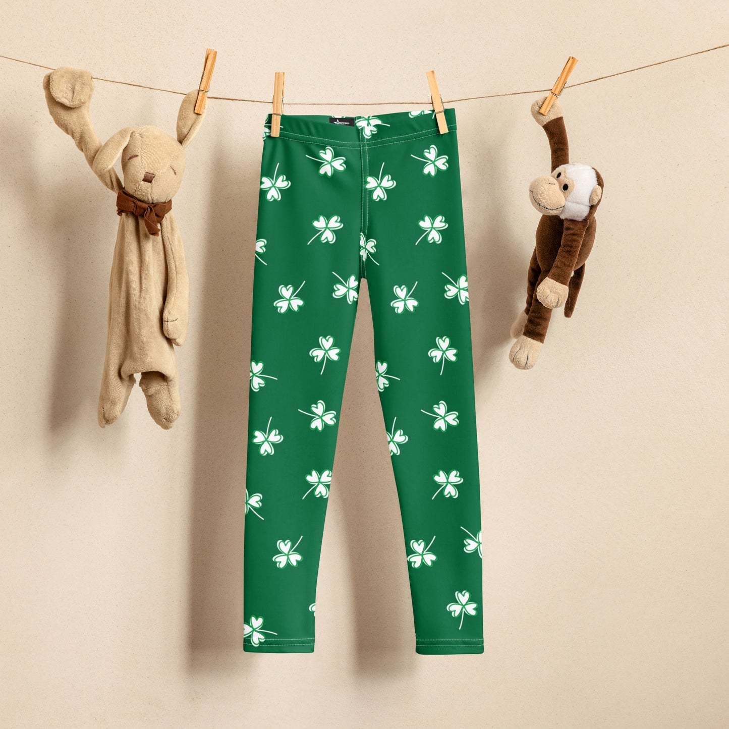 Image: Family Matching St Patricks Day Shamrock Leggings. Festive yoga pants with green background and white four leaf clovers. Available in sizes for toddler girls, teens, tweens, and women. Perfect for a St Pattys Day parade or fun run, by jaecrece