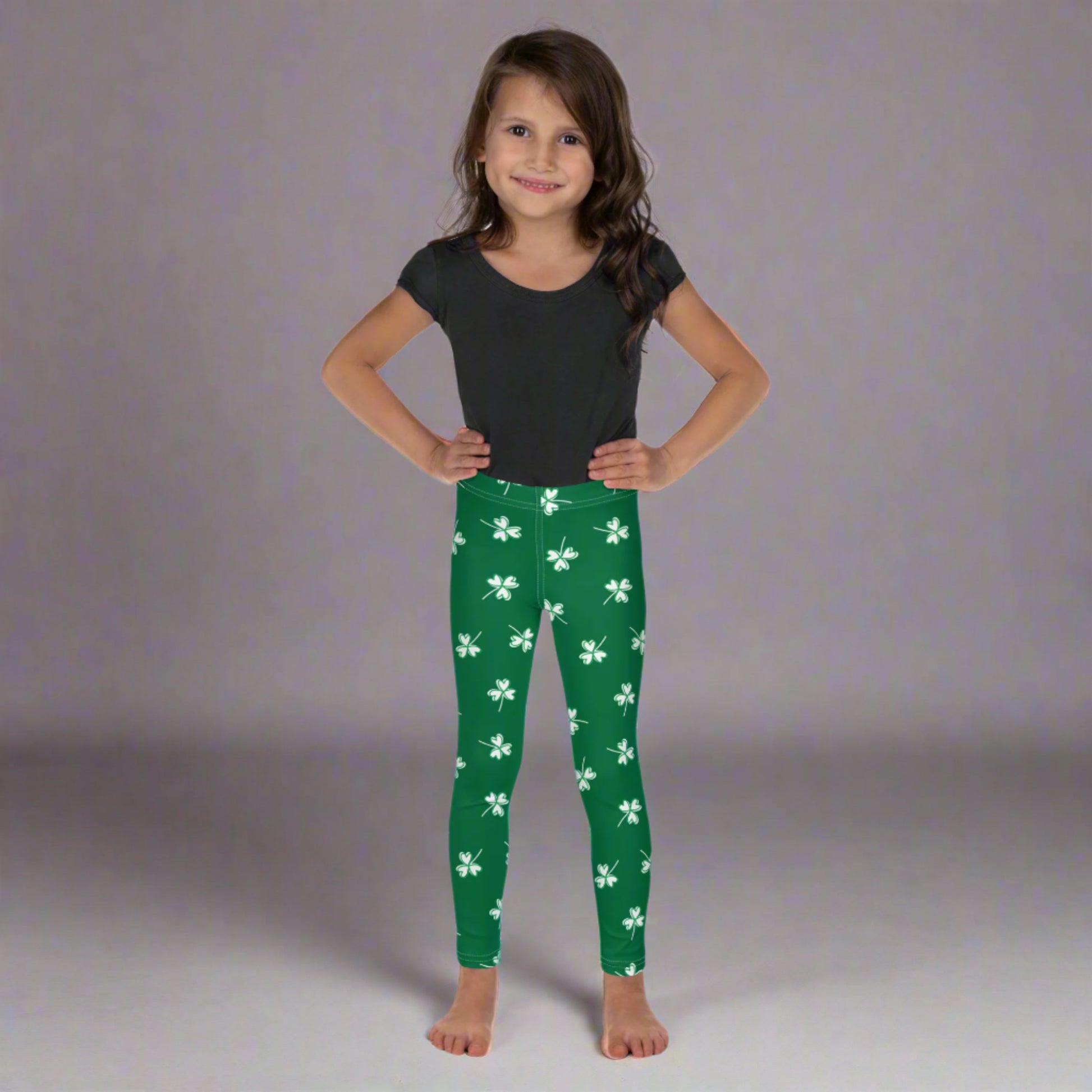 Image: Family Matching St Patricks Day Shamrock Leggings. Festive yoga pants with green background and white four leaf clovers. Available in sizes for toddler girls, teens, tweens, and women. Perfect for a St Pattys Day parade or fun run, by jaecrece