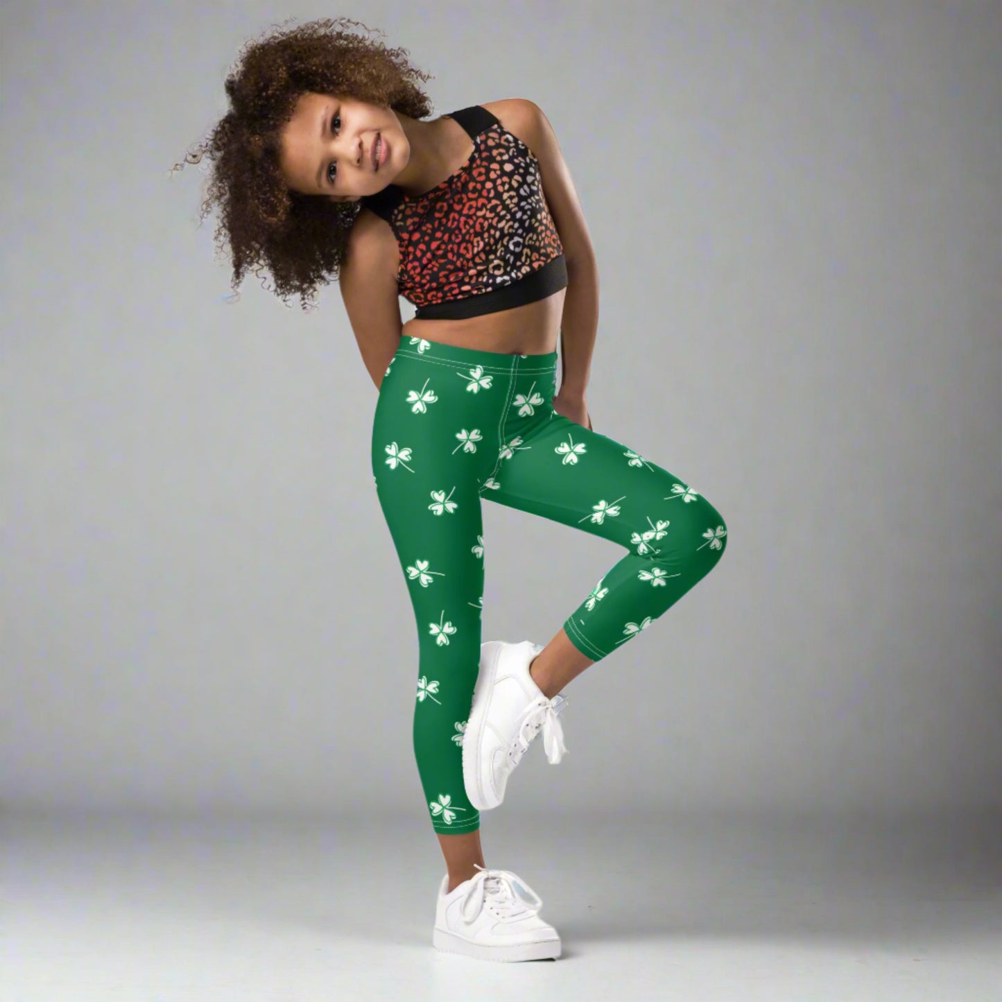 Image: Family Matching St Patricks Day Shamrock Leggings. Festive yoga pants with green background and white four leaf clovers. Available in sizes for toddler girls, teens, tweens, and women. Perfect for a St Pattys Day parade or fun run, by jaecrece