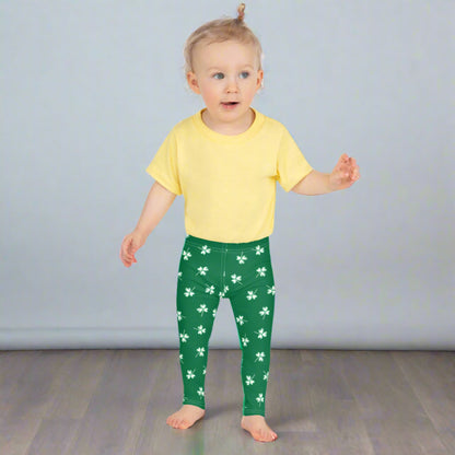 Image: Family Matching St Patricks Day Shamrock Leggings. Festive yoga pants with green background and white four leaf clovers. Available in sizes for toddler girls, teens, tweens, and women. Perfect for a St Pattys Day parade or fun run, by jaecrece